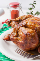 Baked chicken on white plate.