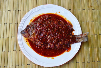 deep fried mango fish dressing chili sauce on plate