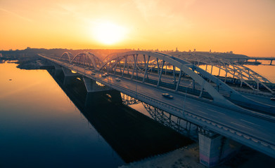 Darnitskiy bridge across Dnepr river against sunset sky. Kiev, Ukraine