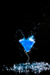 blue cocktail with splash and ice vapor