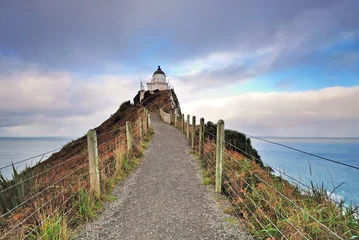 Foto op Plexiglas Lighthouse on Nugget Point. It is located in the Catlins area on the Southern Coast of New Zealand, Otago region. Photo taken in long exposure. © cn0ra