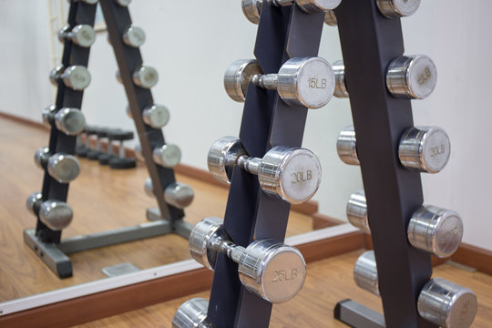 group of dumbbell on rack in workout room