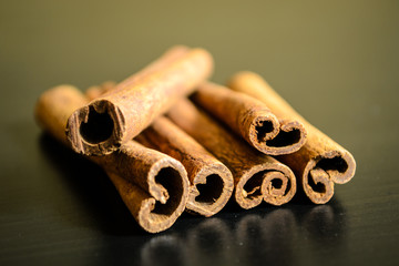 Spices cinnamon sticks on a wooden table