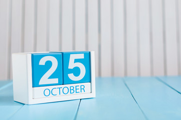 October 25th. Image of October 25 wooden color calendar on white background. Autumn day. Empty space for text