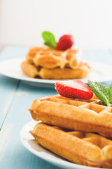 Waffles with ice cream on blue wood

