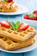 Waffles with ice cream on blue wood
