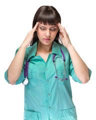 Female doctor tired with headache isolated on white