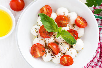 salad with mozzarella, basil and cherry tomatoes, top view