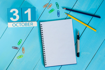 October 31st. Image of October 31 wooden color calendar on blue background. Autumn day. Empty space...