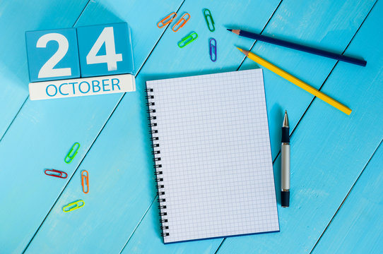 October 24th. Image of October 24 wooden color calendar on blue background. Autumn day. Empty space for text