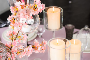 Obraz na płótnie Canvas Wedding decoration for banquet with sakura and candles
