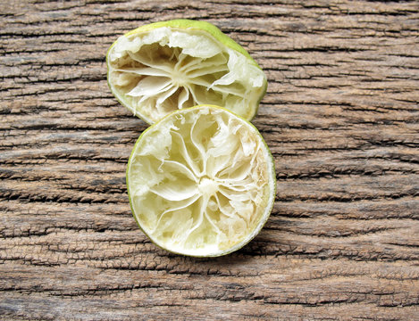 Squeezed Of Lime On Wooden Texture,lemon Peel