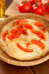 Focaccia with tomatoes and olive oil, homemade, close up