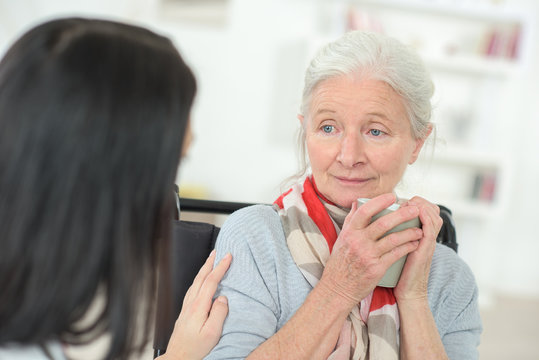 Doctor Visiting A Sad Senior Patient