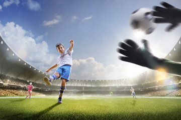 Childrens are playing soccer on grand arena