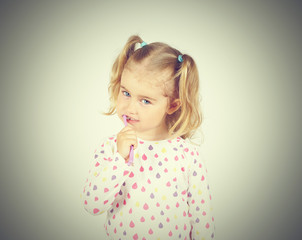Little girl brushing her teeth.