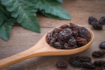Raisins on wooden spoon