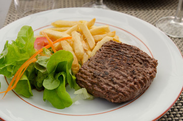 A meal of burger, chips and salad