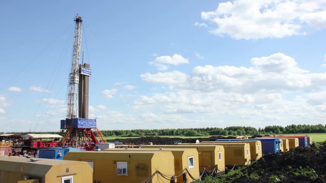 Clouds over oil gas drilling rig