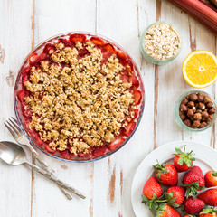 Rhubarb and Strawberry crumble with all ingredients nearby