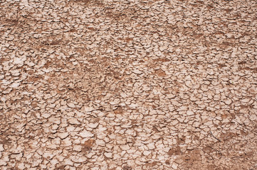 Background of dry cracked earth in a dried up river bed