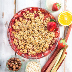 Rhubarb and Strawberry crumble with all ingredients nearby