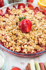 Rhubarb and Strawberry crumble with all ingredients nearby
