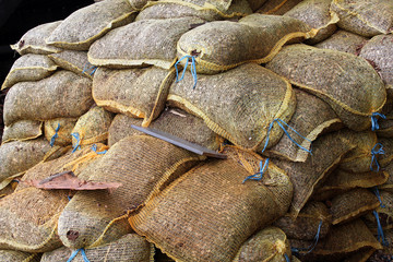 Stored tied canvas bags, full bags stacked on each other