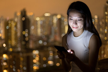 Woman use of cellphone at night