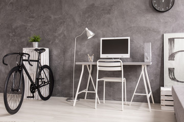 Black bicycle in grey and white living room