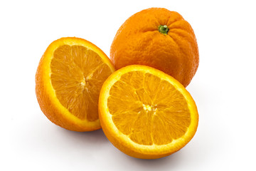 Two raw organic oranges, one cutted in half, isolated on white background