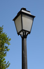 Fototapeta na wymiar Old fashioned lamp post against a blue sky