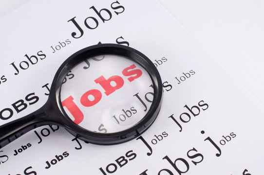Job search concept with magnifying glass highlighting the word Job