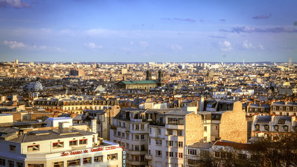 Fototapeta premium Paris, France - April 5, 2016: View of Parisian rooftops from the top of Montmartre hill