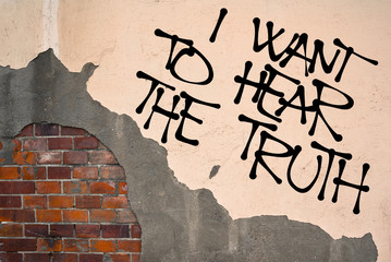 Handwritten graffiti I Want To Hear The Truth sprayed on wall, anarchist aesthetics. Protest...
