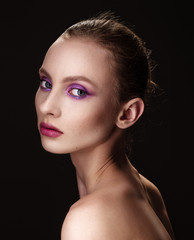 Fototapeta premium Close up portrait of a beautiful brunette girl with pink makeup