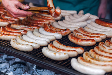 rows of bratwurst on a large grill © Christian Müller