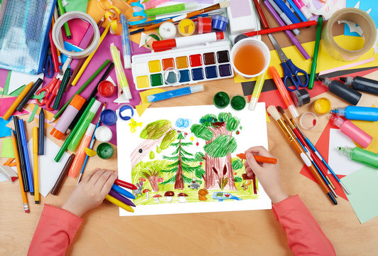 forest and wildlife animals child drawing, top view hands with pencil painting picture on paper, artwork workplace