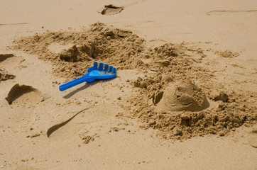 Remains of a sandcastle on the beach