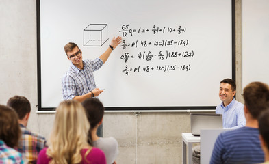 group of students and teacher at white board