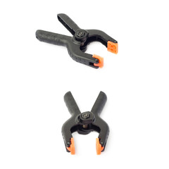 Set of Clamp with orange plastic jaws, isolated over the white background