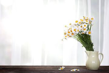 Bouquet of wildflowers on a rustic table at country cottage