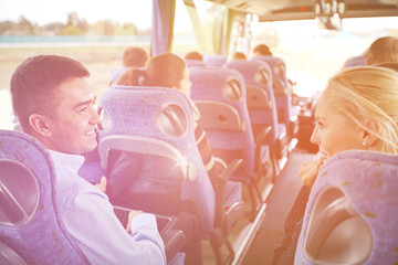 group of happy passengers in travel bus