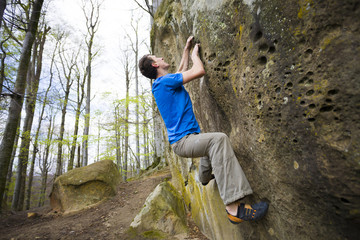 Climber is bouldering on the rocks.