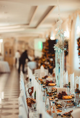 Beautiful wedding restaurant for marriage. White decor for bride and groom. Colorful decoration for celebration. Beauty bridal interior. Bouquet and flowers in hall