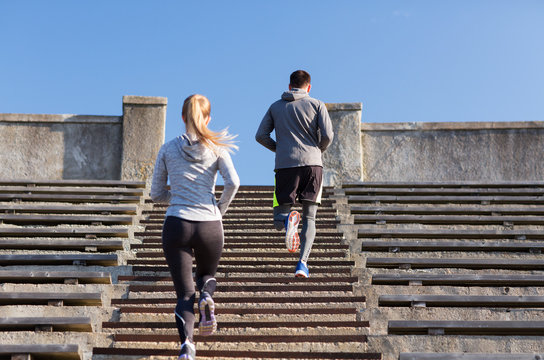 couple running upstairs on stadium