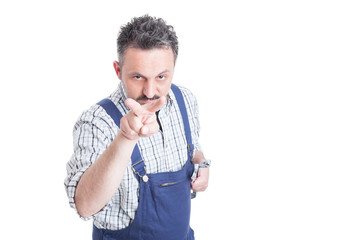 Young mechanic doing I am watching you gesture