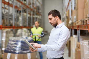 businessman with tablet pc at warehouse