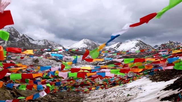 Fluttering Tibetan prayer flags with SNOW MOUNTAIN, YADING, China