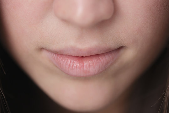 Close up shot of the full lips young woman